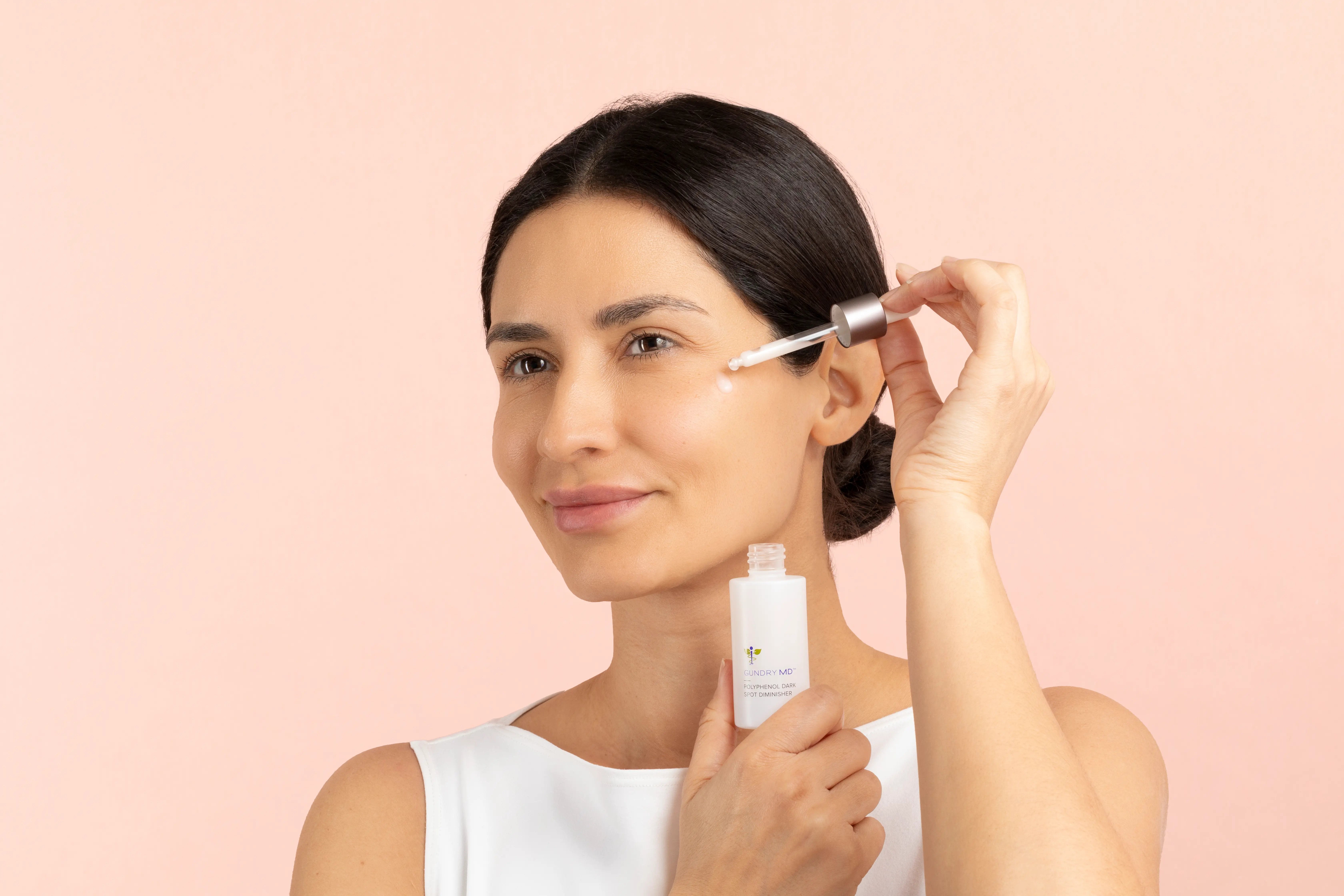 Confident woman showing clear even-toned skin on arms and chest